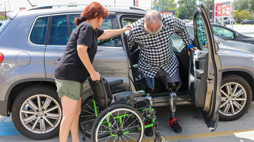 Double leg amputee getting out of a car